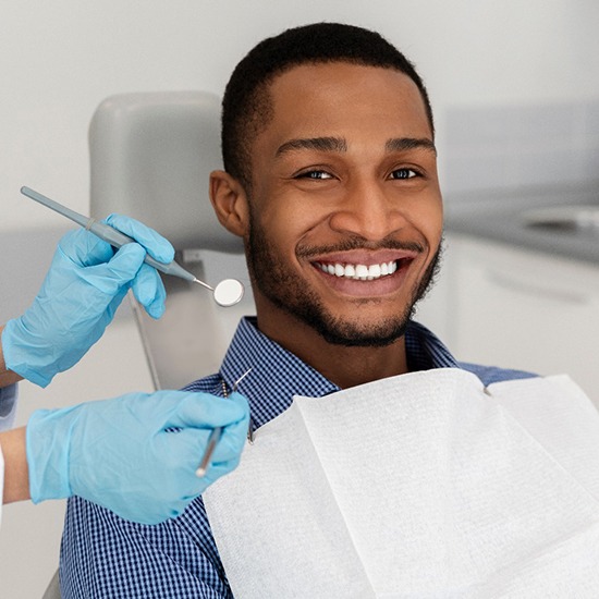 Patient in Fairfax smiling at their dental checkup