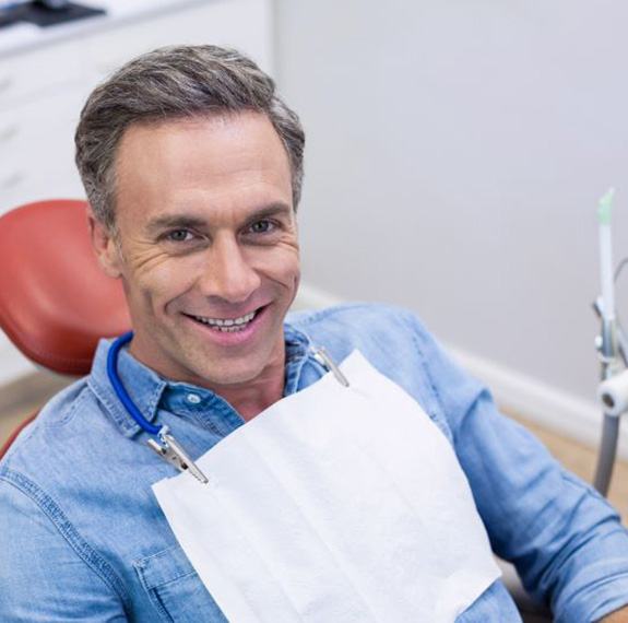 Happy middle-aged male dental patient