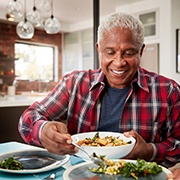 Man eating a nutrient-rich meal with dentures