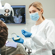 Dentist showing patient clear aligner in treatment room